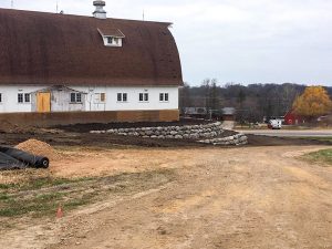 a barn with a new retaining wall
